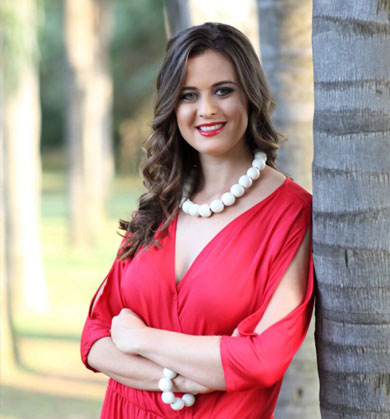 Antonia in red dress against tree